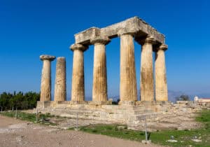 The stepped foundation and seven standing columns of the Temple of Apollo, in Corinth.