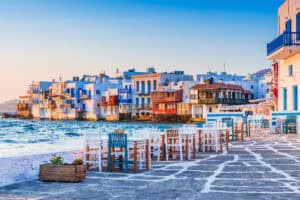 Colorful tables and chairs outside of a harbor-side restaurant on Mykonos Island.